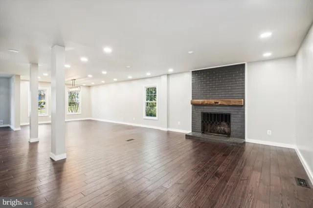 a large white kitchen with a large window a sink and stainless steel appliances