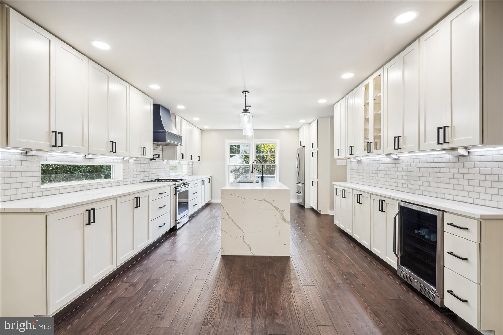 2613 Mountain Laurel Place Reston, VA 20191 - Photo 6 of 78 a large white kitchen with a large window a sink and stainless steel appliances
