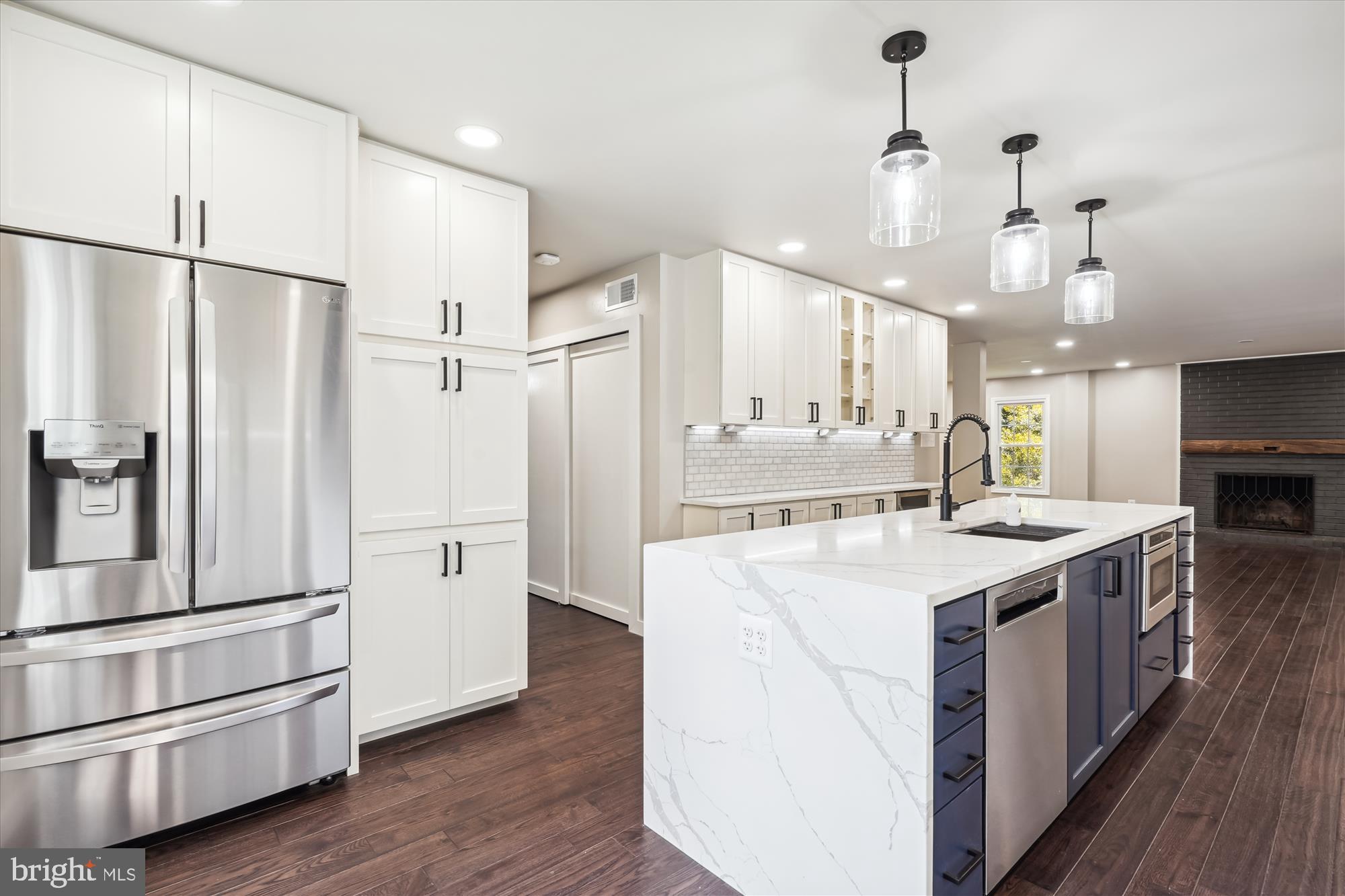 2613 Mountain Laurel Place Reston, VA 20191 - Photo 8 of 78 a large kitchen with stainless steel appliances a refrigerator a oven and a stove with wooden floor