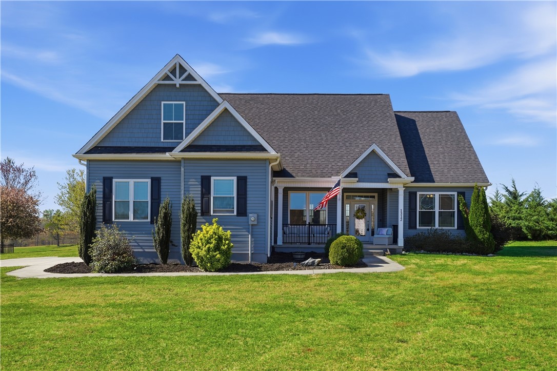 This charming home offers a welcoming facade with classic architectural details and manicured landscaping.