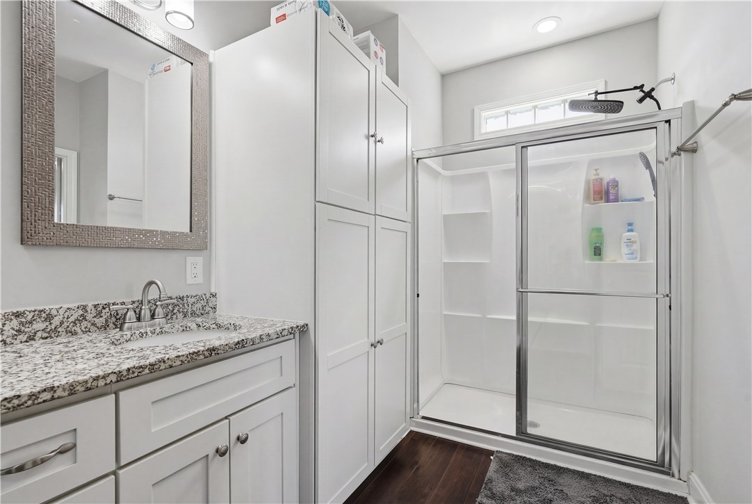 1312 Falcons Drive Walhalla, SC 29691 - Photo 15 of 34 This sleek bathroom boasts a modern vanity with granite counters and a spacious walk-in shower.