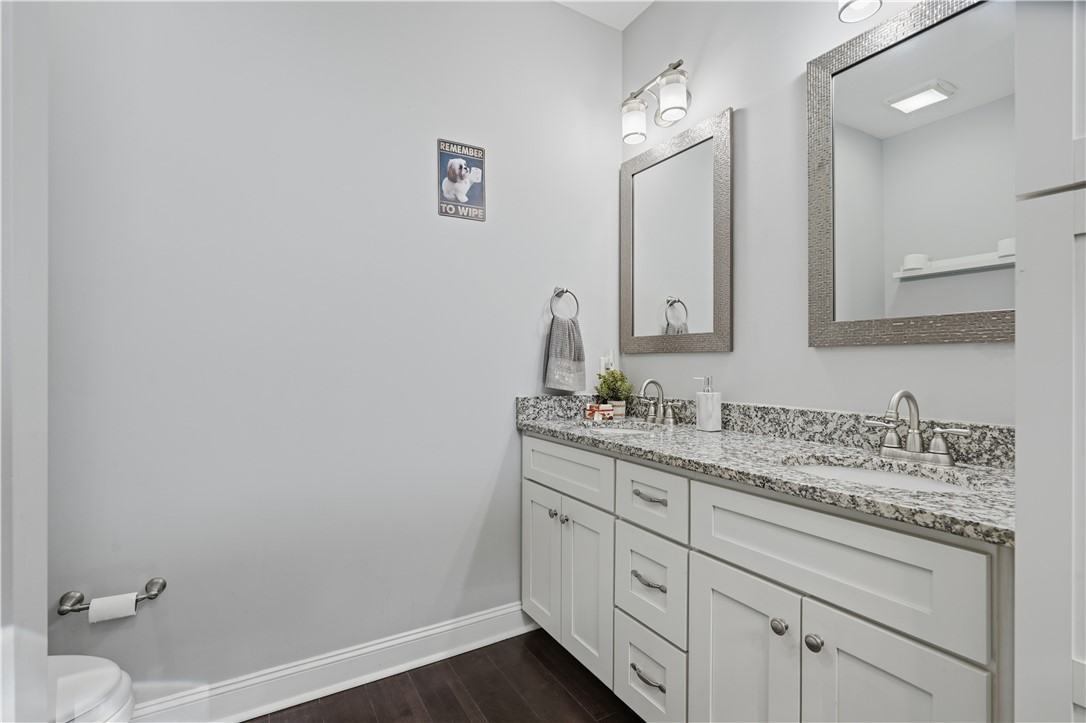 1312 Falcons Drive Walhalla, SC 29691 - Photo 16 of 34 This modern bathroom features a dual vanity, rich flooring, and ample lighting.