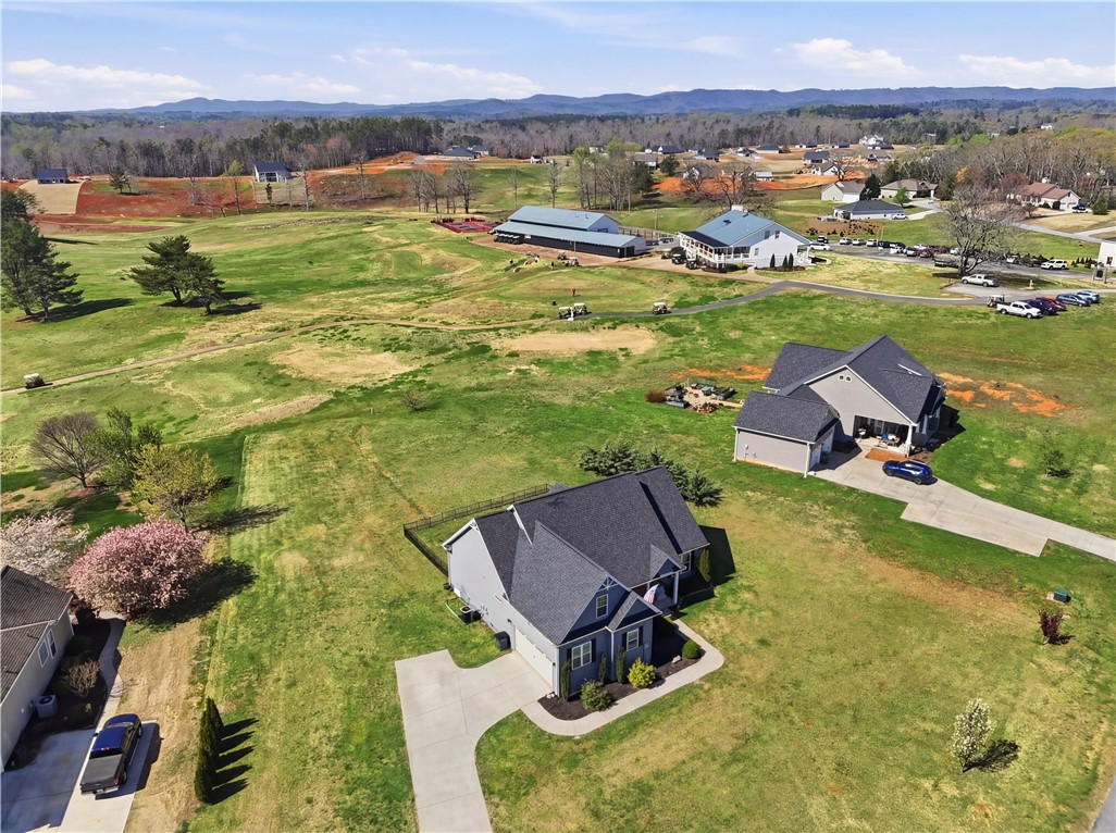 1312 Falcons Drive Walhalla, SC 29691 - Photo 28 of 34 This aerial view showcases a residential property nestled within a vast, open landscape.