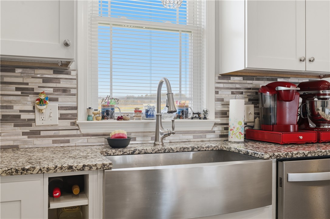 1312 Falcons Drive Walhalla, SC 29691 - Photo 8 of 34 This modern kitchen features a spacious sink and elegant backsplash, perfect for culinary endeavors.