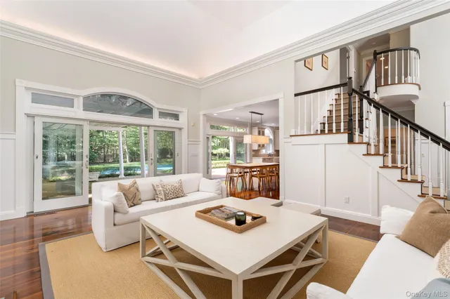 a living room with furniture a table and a large window