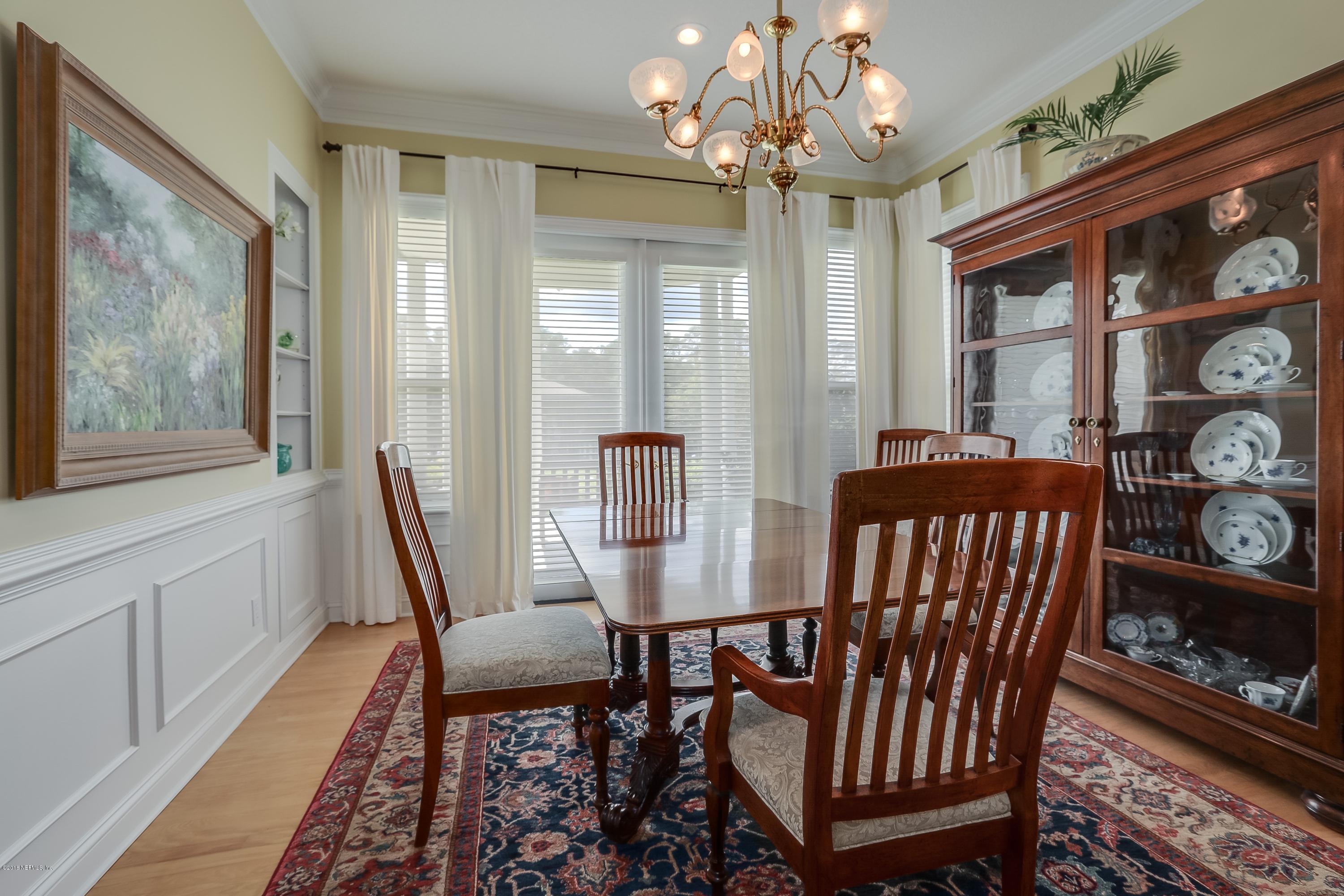 41 Cat Road Ponte Vedra Beach, FL 32082 - Photo 7 of 36 a view of a dining room with furniture wooden floor and chandelier