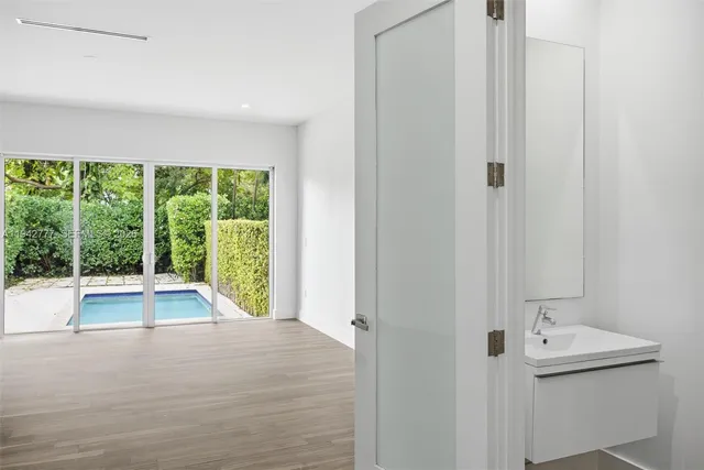 a view of an empty room with a window and tub