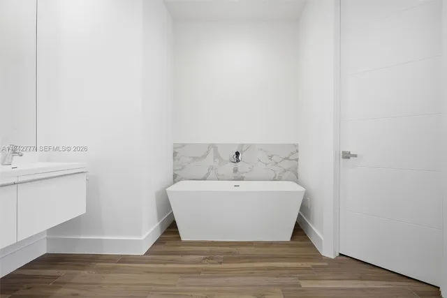 a spacious bathroom with a bathtub and sink
