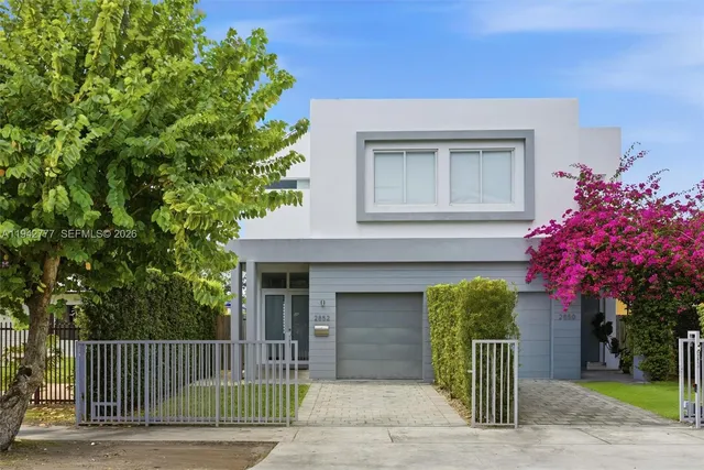 a front view of a house with a garden