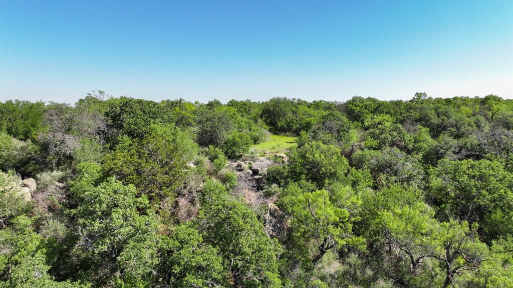 Tbd Lot 18.3 Tbd Road Gordon, TX 76453 - Photo 20 of 40 an aerial view of a houses with a lush green forest