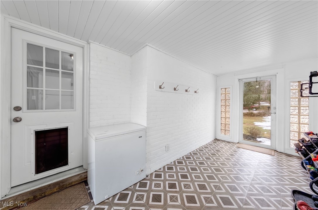 1051 Rockside Road Independence, OH 44131 - Photo 27 of 30 Mudroom featuring wooden ceiling, brick wall, and tile patterned floors