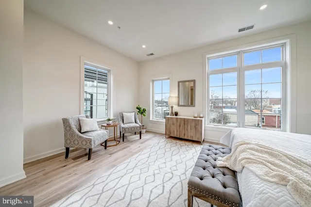 a bedroom with a bed and a couch