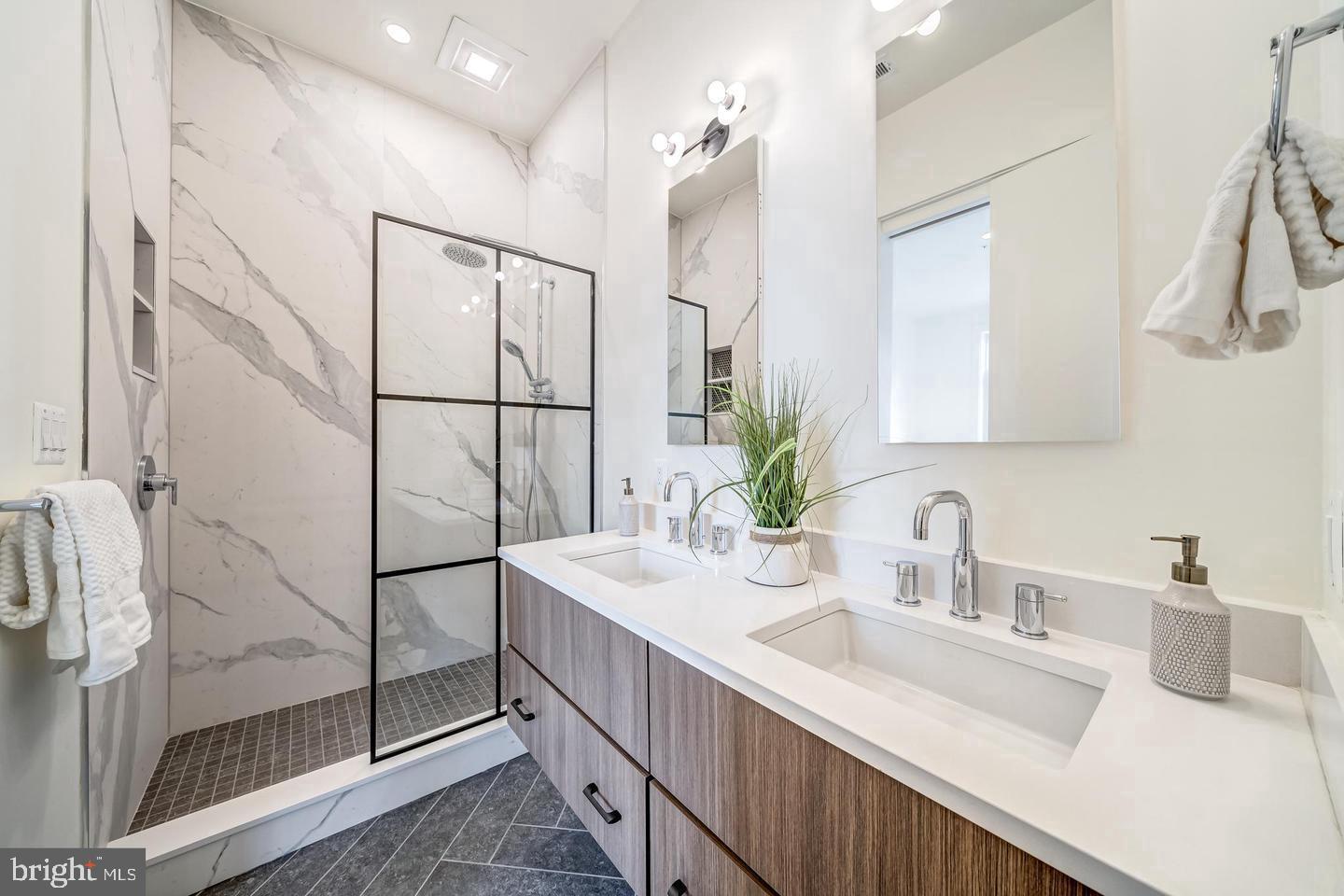 442.5 R Street Northwest, Unit B Washington, DC 20009 - Photo 15 of 25 a bathroom with a double vanity sink mirror and shower