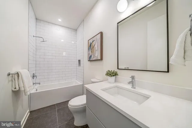 a spacious bedroom with a bed and a large window