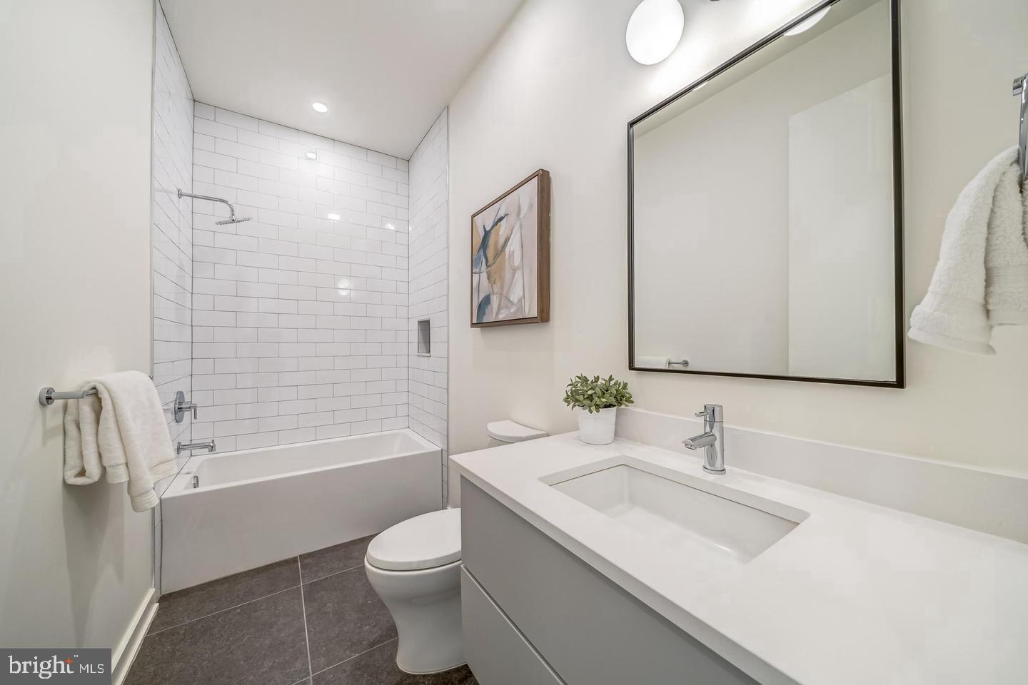 442.5 R Street Northwest, Unit B Washington, DC 20009 - Photo 17 of 25 a bathroom with a granite countertop sink toilet and shower