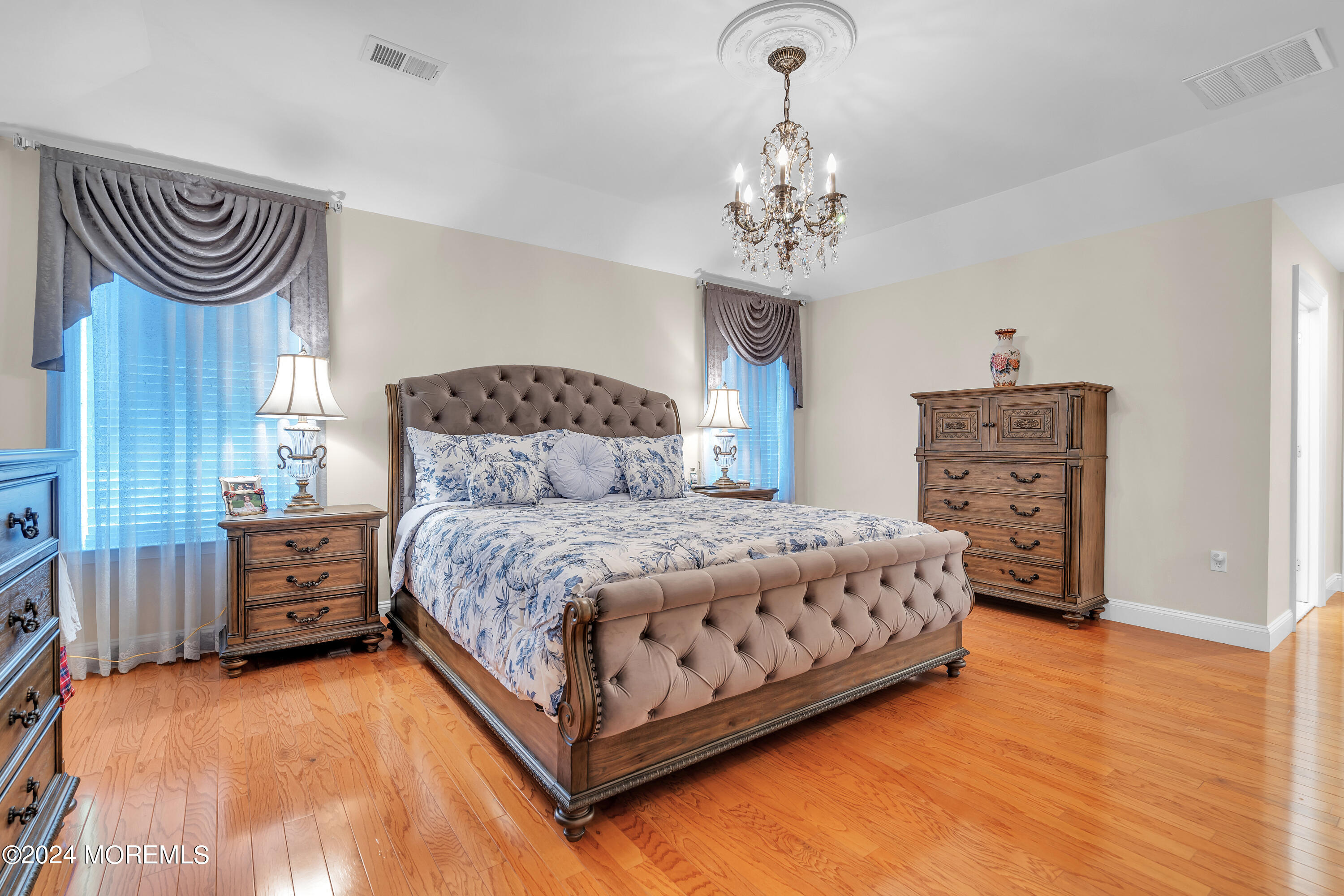 2050 MacKenzie Road Toms River, NJ 08755 - Photo 55 of 95 a bedroom with a bed and a chandelier