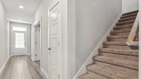 a view of an entryway with wooden floor
