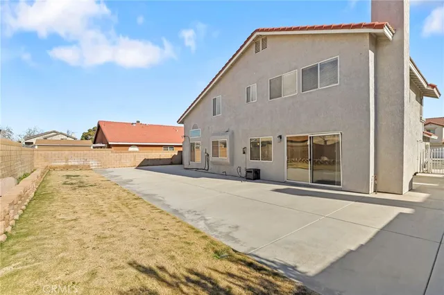 a view of a white house with a outdoor space
