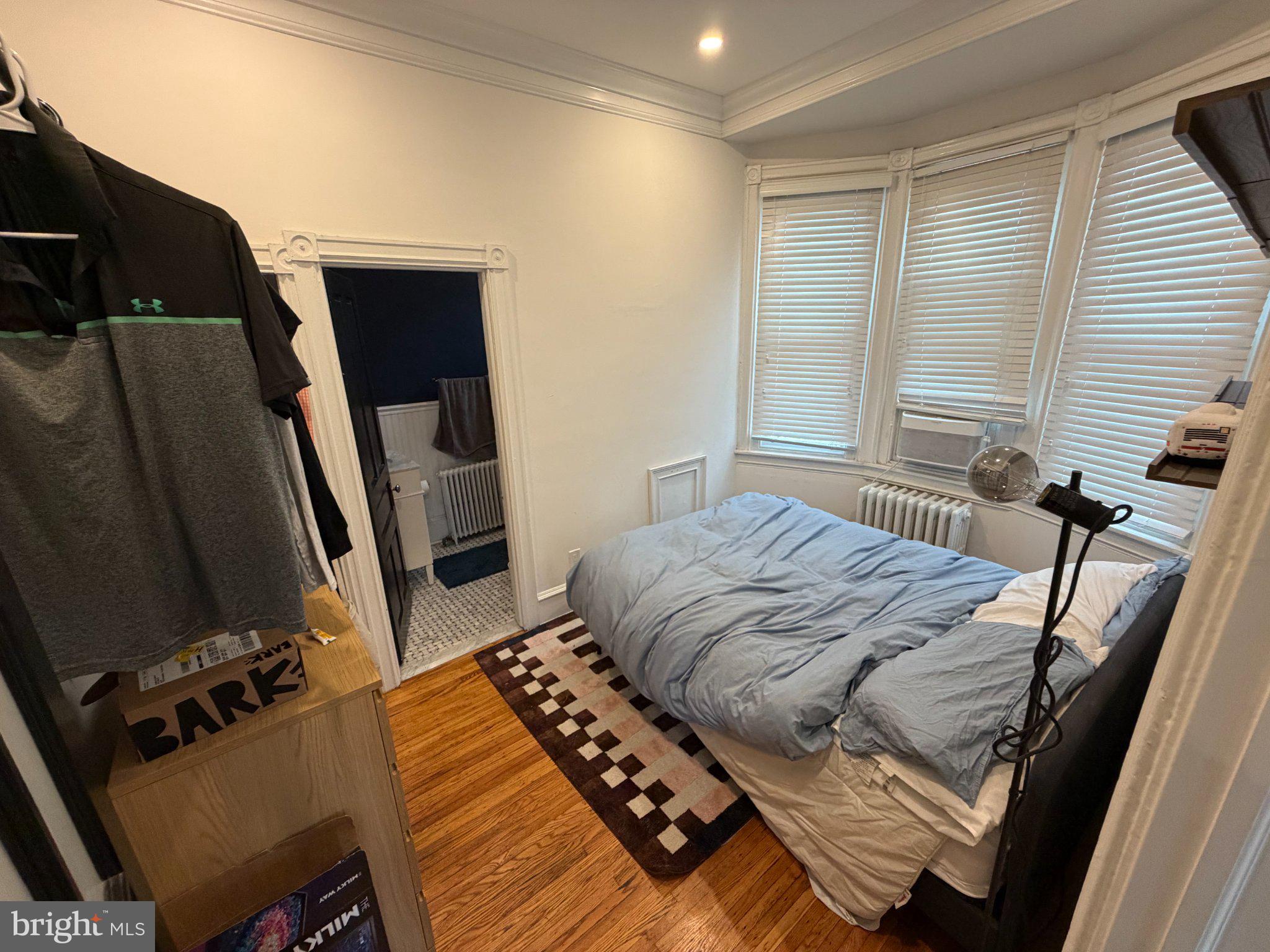 815 South 49th Street Philadelphia, PA 19143 - Photo 20 of 72 a bedroom with a bed and a flat tv screen