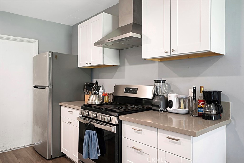 3076 Ronald Street Riverside, CA 92506 - Photo 13 of 26 a kitchen with stainless steel appliances granite countertop a sink stove and refrigerator