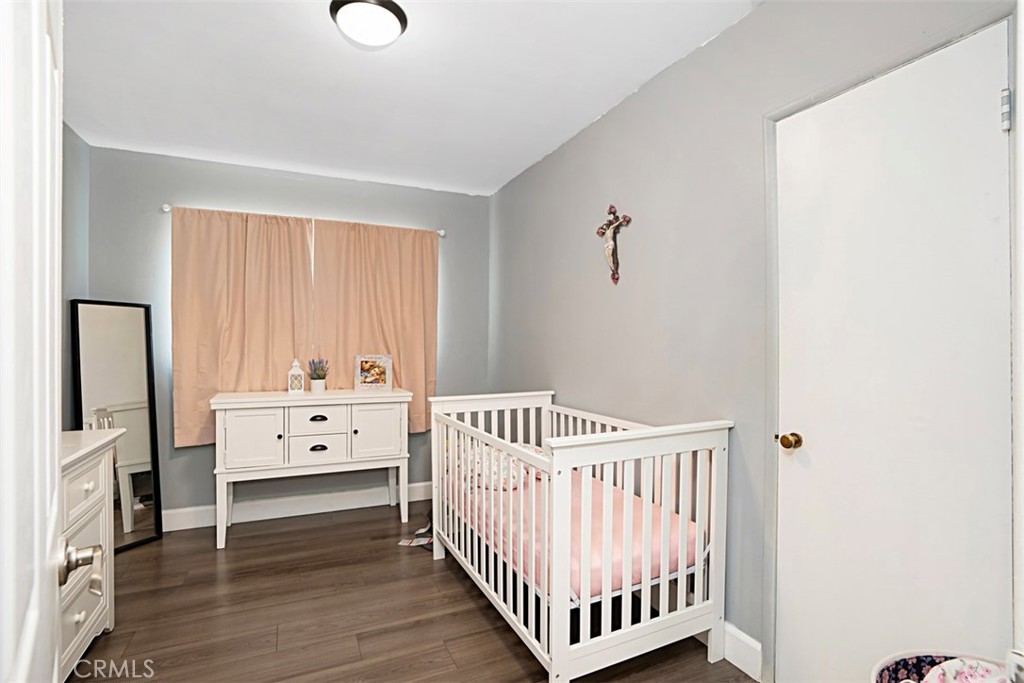 3076 Ronald Street Riverside, CA 92506 - Photo 19 of 26 a bedroom with a bed and wooden floor