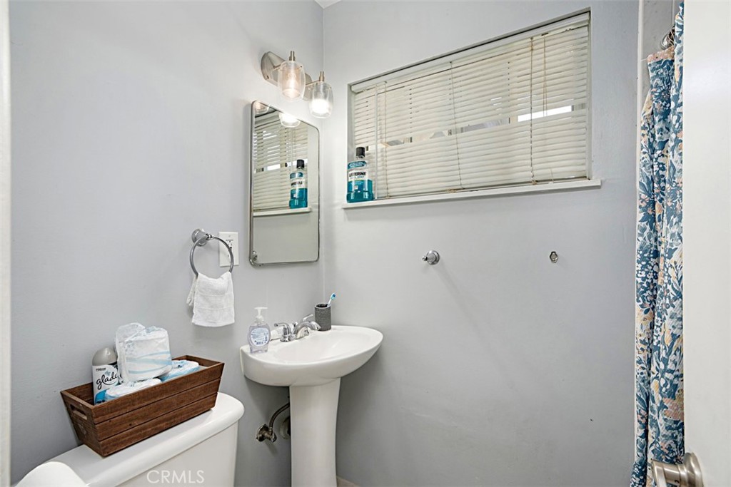 3076 Ronald Street Riverside, CA 92506 - Photo 20 of 26 a bathroom with a sink a mirror and a shower