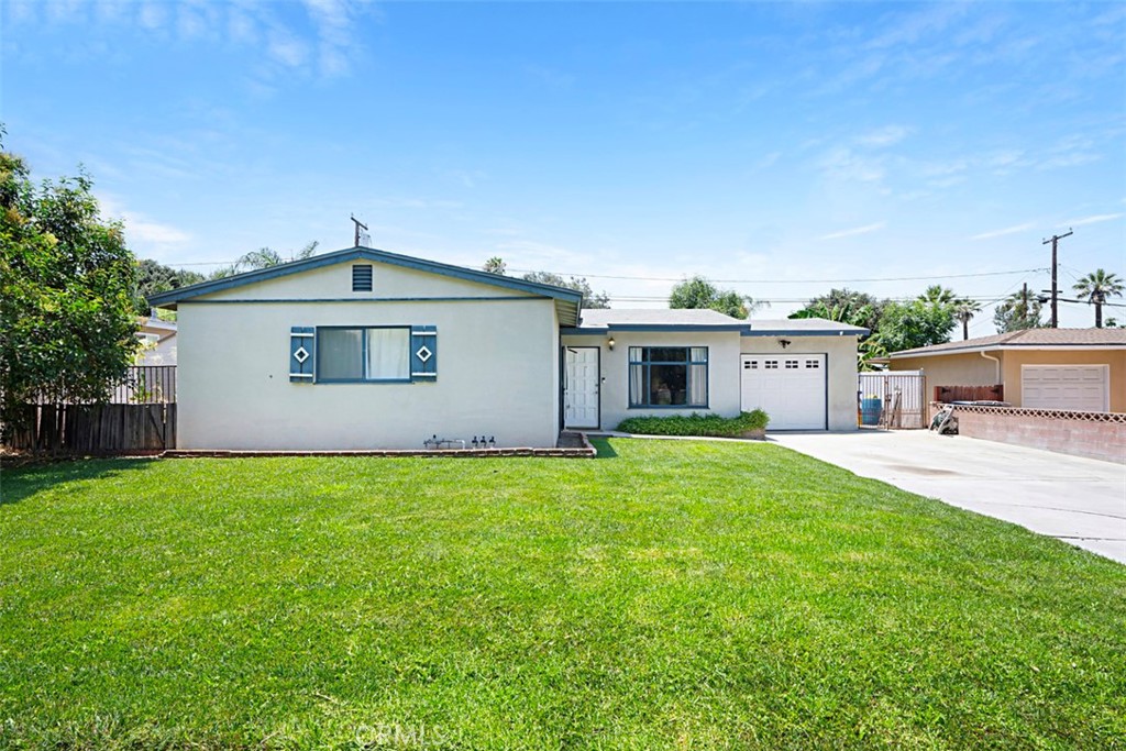 3076 Ronald Street Riverside, CA 92506 - Photo 2 of 26 a front view of a house with a garden