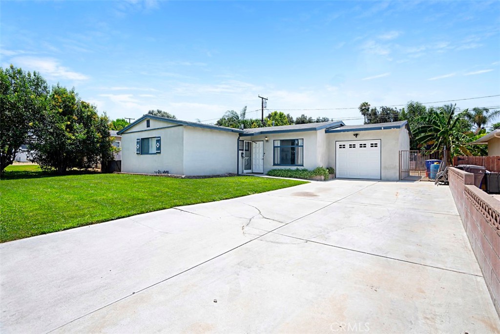 3076 Ronald Street Riverside, CA 92506 - Photo 4 of 26 a view of a house with a yard and large tree