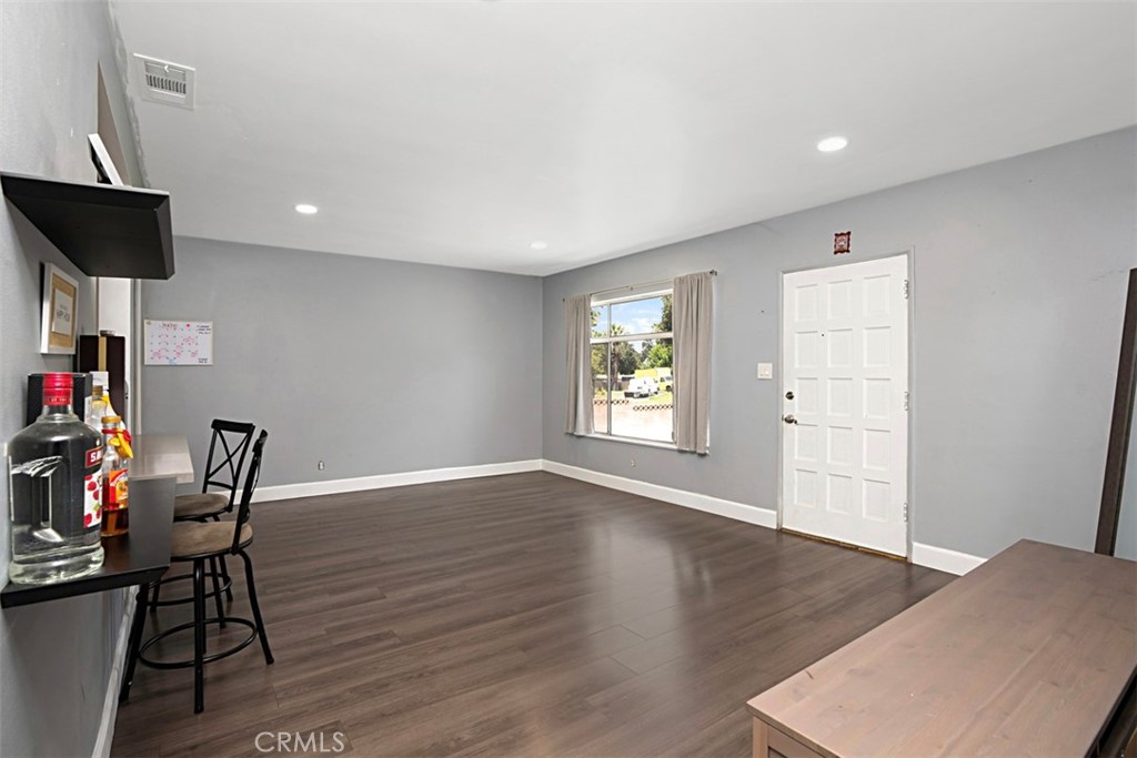 3076 Ronald Street Riverside, CA 92506 - Photo 9 of 26 a view of a room with wooden floor and windows