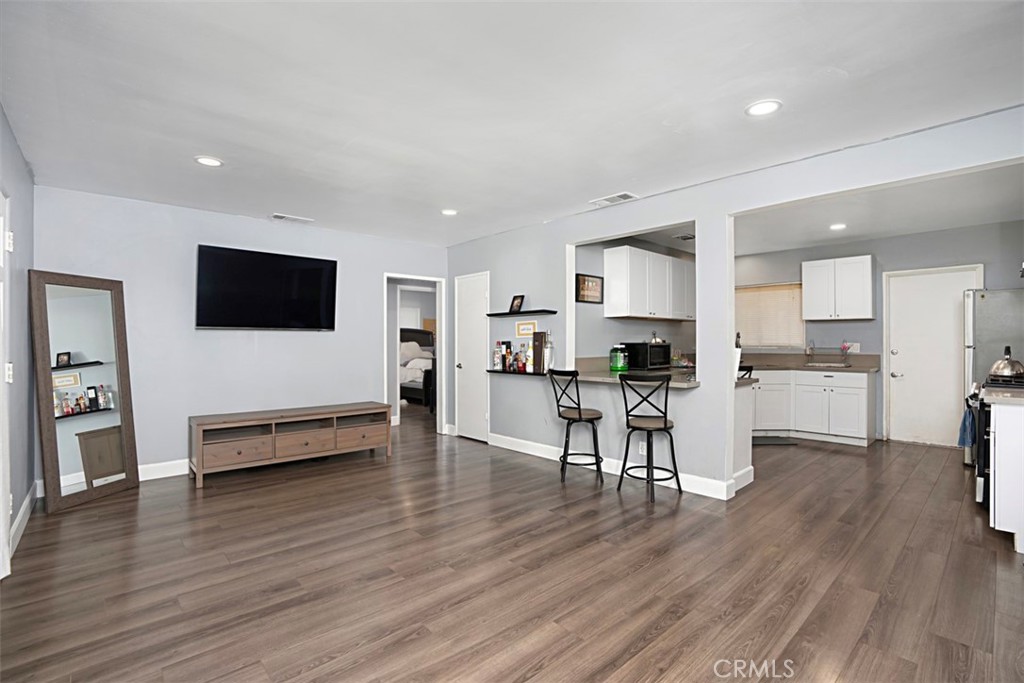 3076 Ronald Street Riverside, CA 92506 - Photo 10 of 26 a living room with furniture wooden floor and a flat screen tv