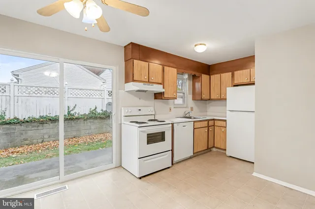 a kitchen with a stove a sink and a refrigerator