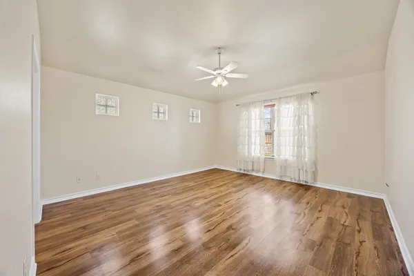 wooden floor in an empty room with a window