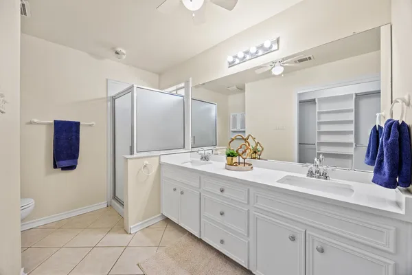 a bathroom with a double vanity sink and mirror