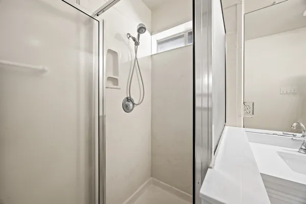 a bathroom with a shower and a sink
