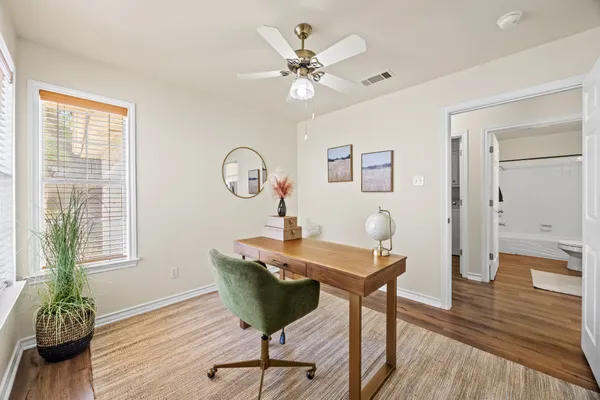 a view of a workspace with furniture and wooden floor