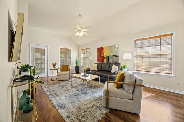 a living room with furniture windows and a flat screen tv