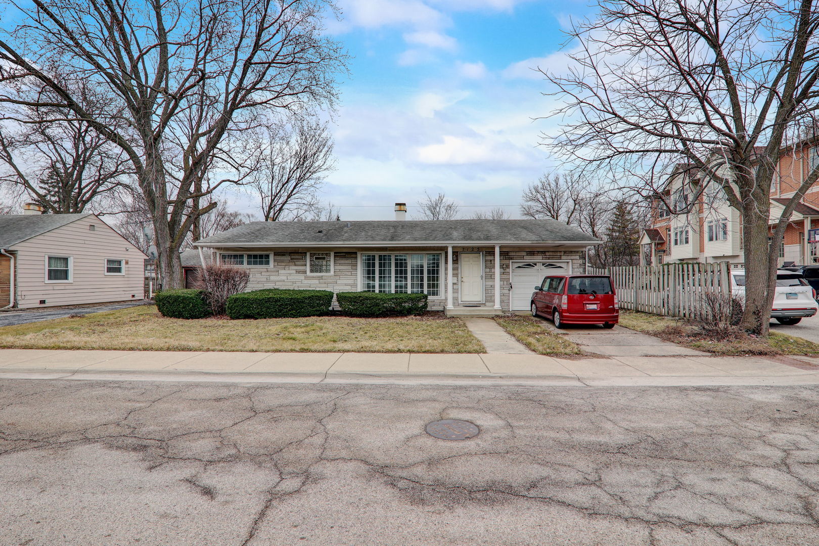 7125 Simpson Street Morton Grove, IL 60053 - Photo 1 of 28 a view of a white house with a large tree