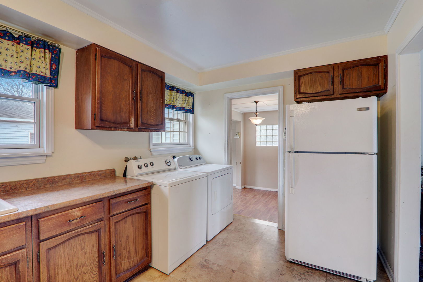 7125 Simpson Street Morton Grove, IL 60053 - Photo 11 of 28 a kitchen with a sink a refrigerator and cabinets
