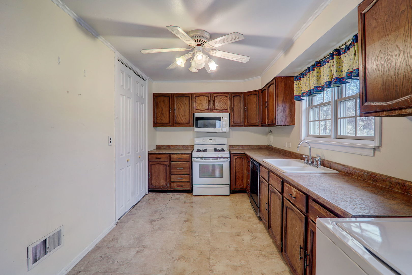 7125 Simpson Street Morton Grove, IL 60053 - Photo 12 of 28 a kitchen with stainless steel appliances granite countertop a stove a sink and a refrigerator