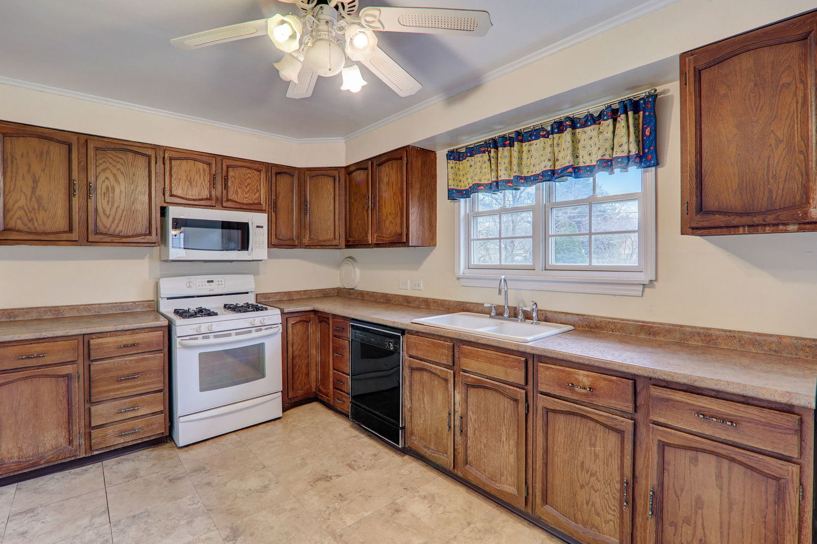 7125 Simpson Street Morton Grove, IL 60053 - Photo 13 of 28 a kitchen with cabinets a sink and appliances