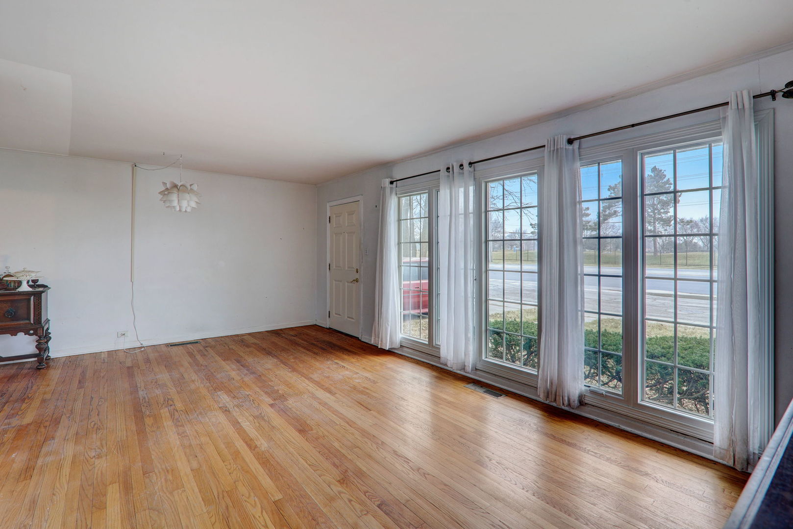 7125 Simpson Street Morton Grove, IL 60053 - Photo 14 of 28 a view of an empty room with wooden floor and a window