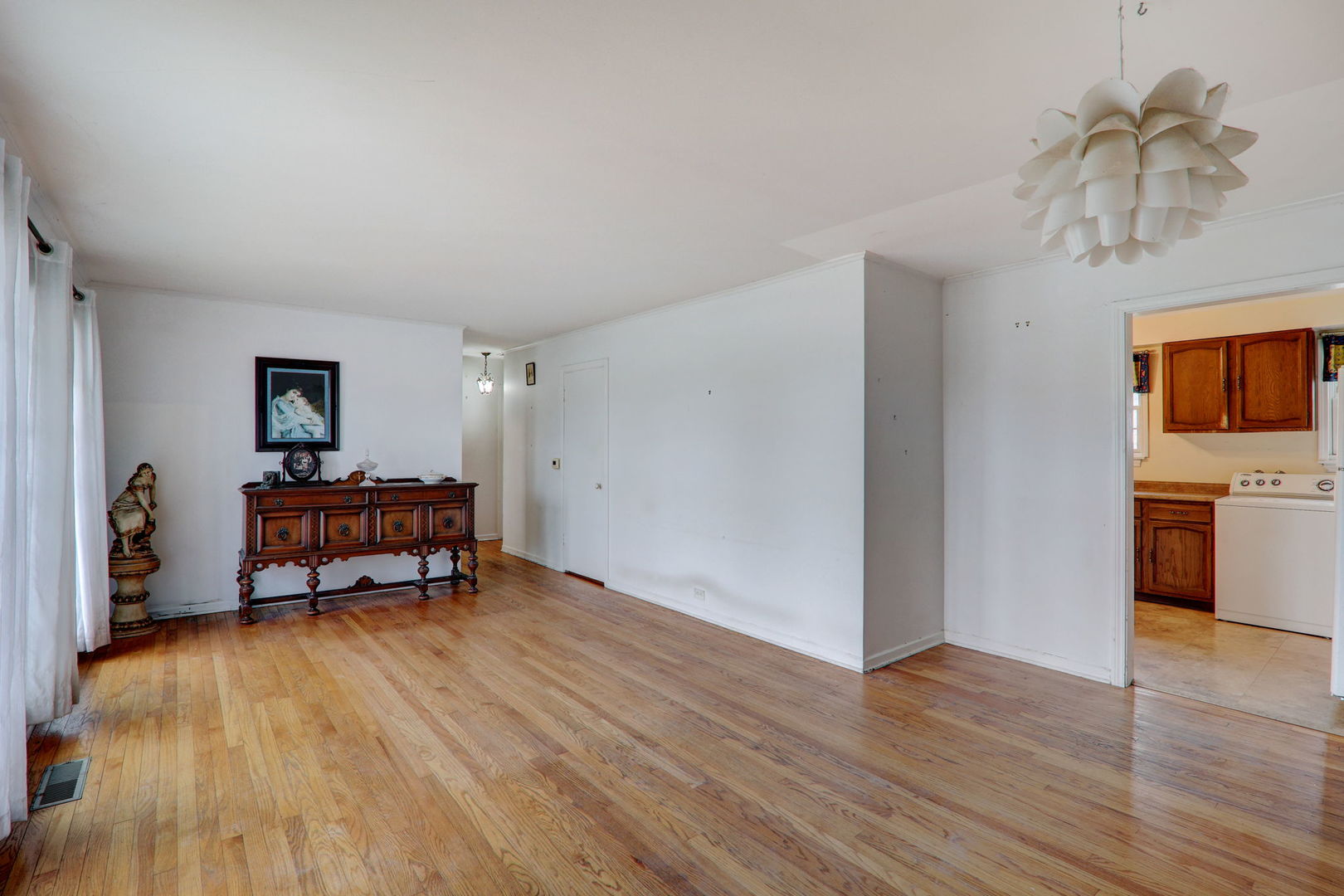 7125 Simpson Street Morton Grove, IL 60053 - Photo 16 of 28 a living room with furniture and a wooden floor