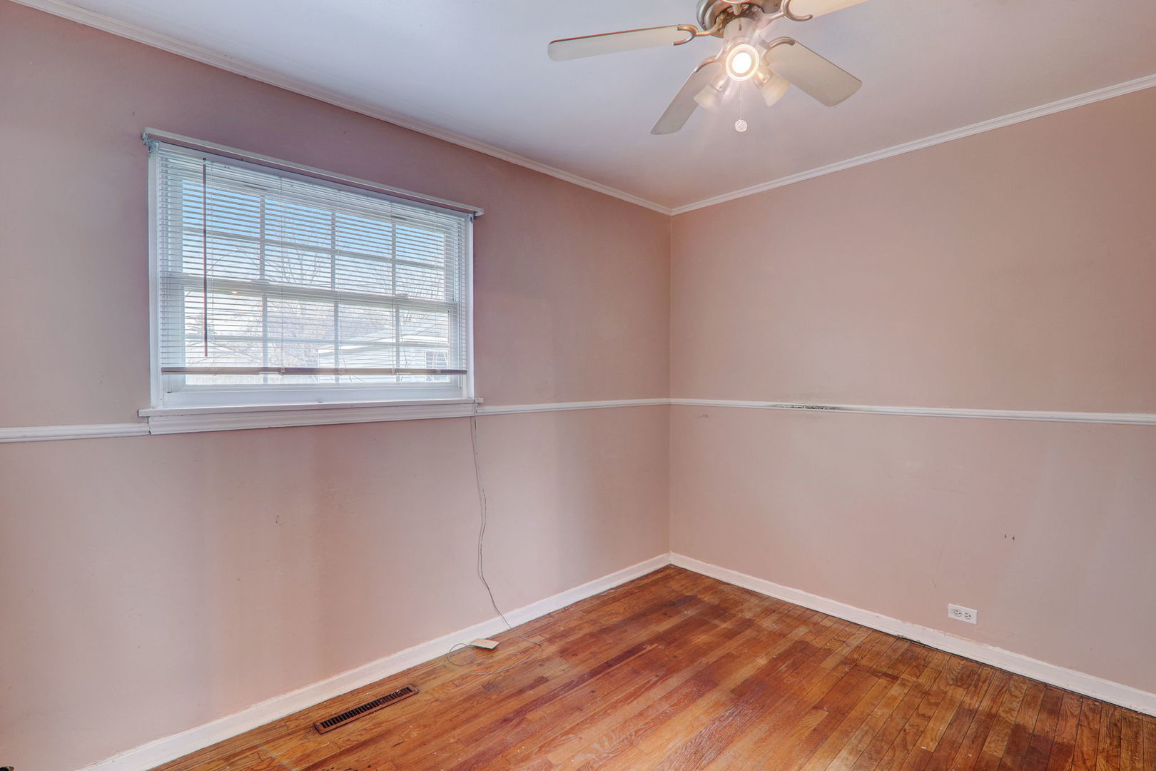 7125 Simpson Street Morton Grove, IL 60053 - Photo 19 of 28 an empty room with a window and wooden floor