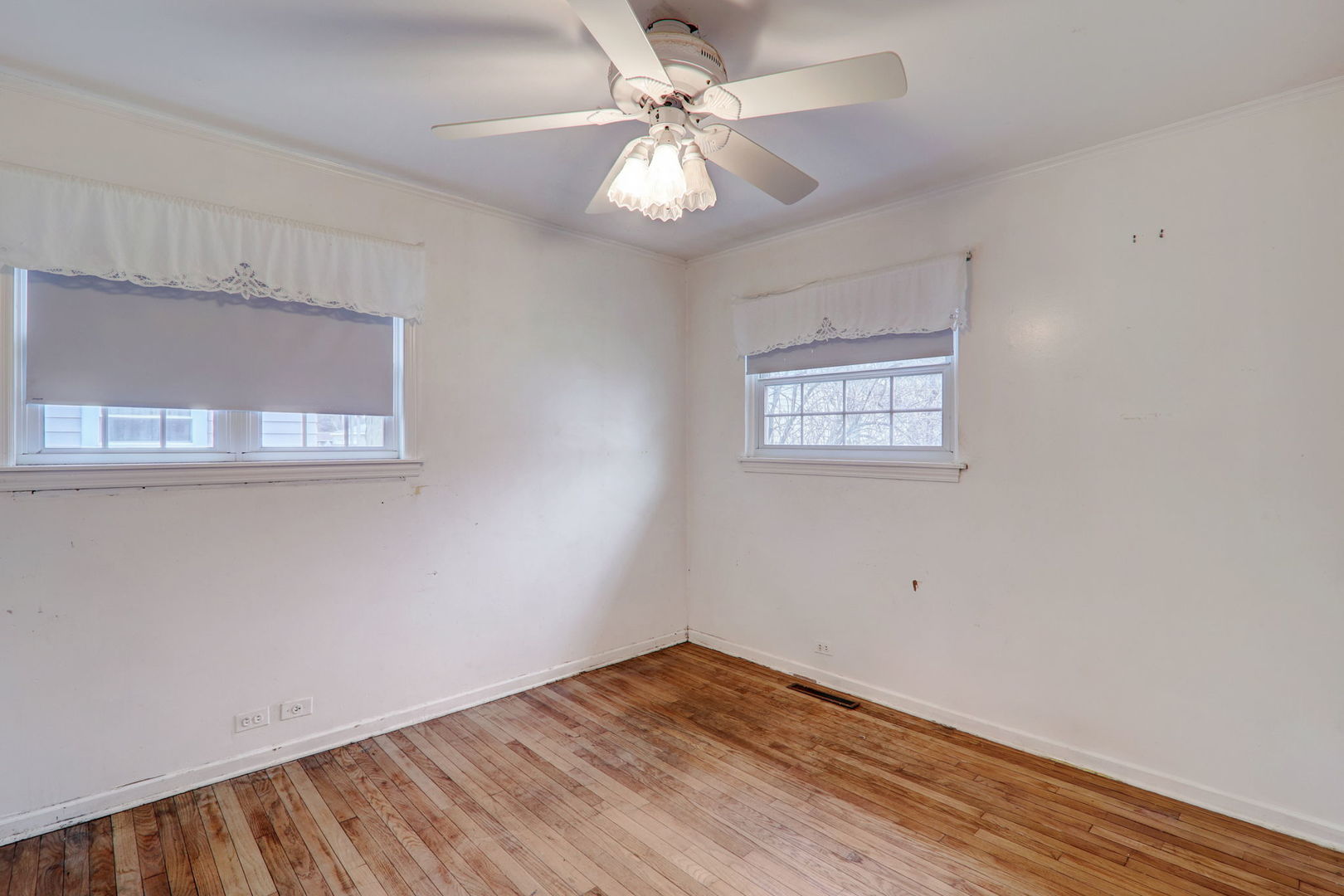 7125 Simpson Street Morton Grove, IL 60053 - Photo 20 of 28 a view of an empty room with window and wooden floor