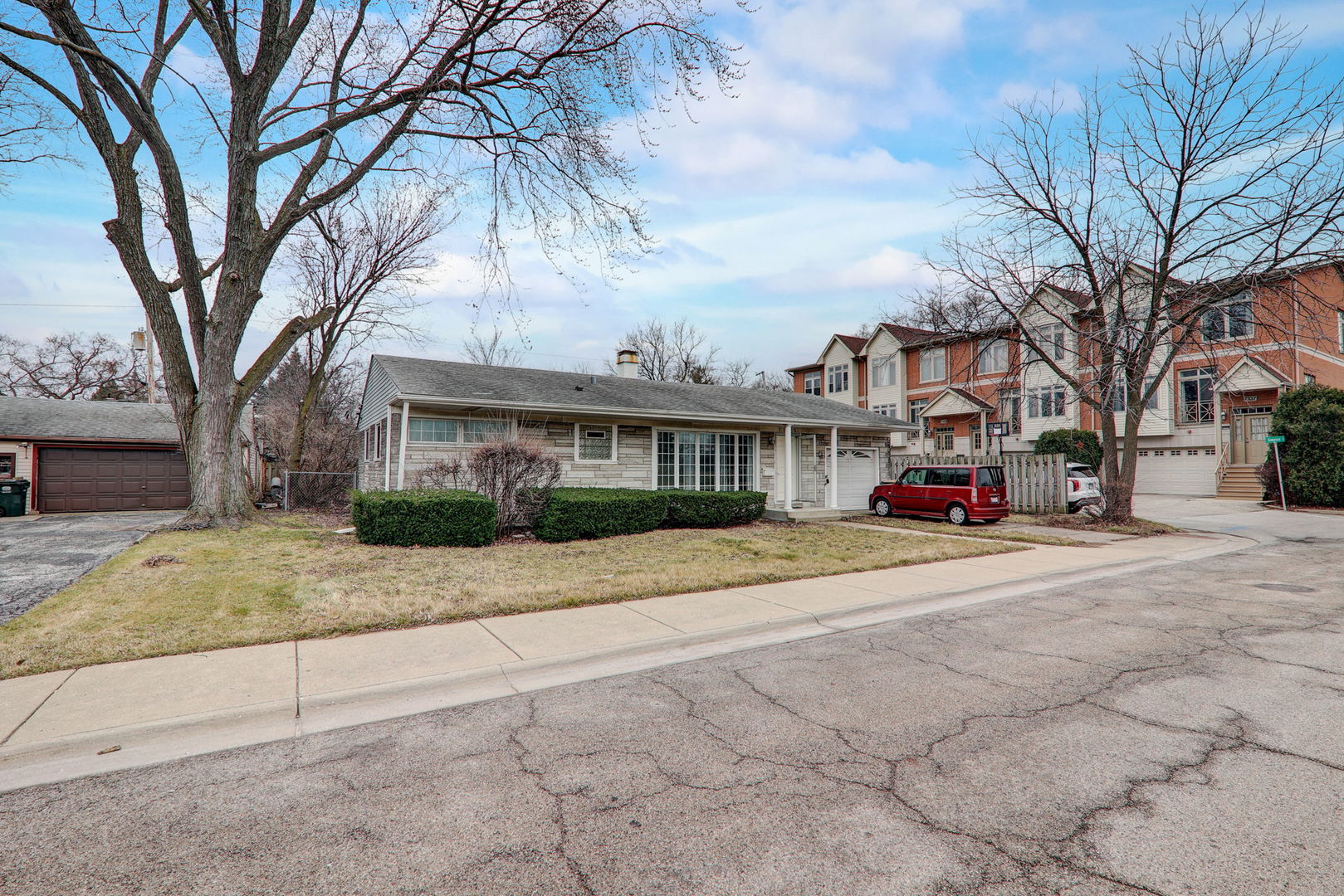 7125 Simpson Street Morton Grove, IL 60053 - Photo 2 of 28 a white house that has a tree on side of it