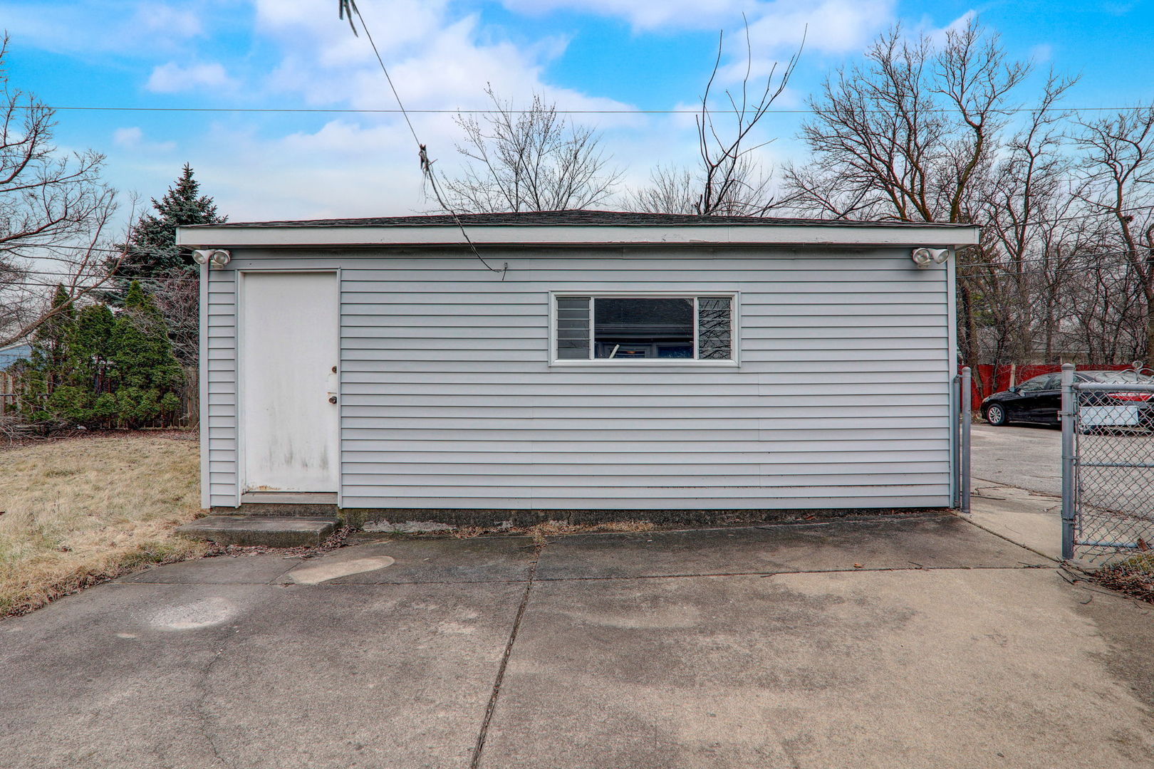 7125 Simpson Street Morton Grove, IL 60053 - Photo 25 of 28 a side view of a house with a fence