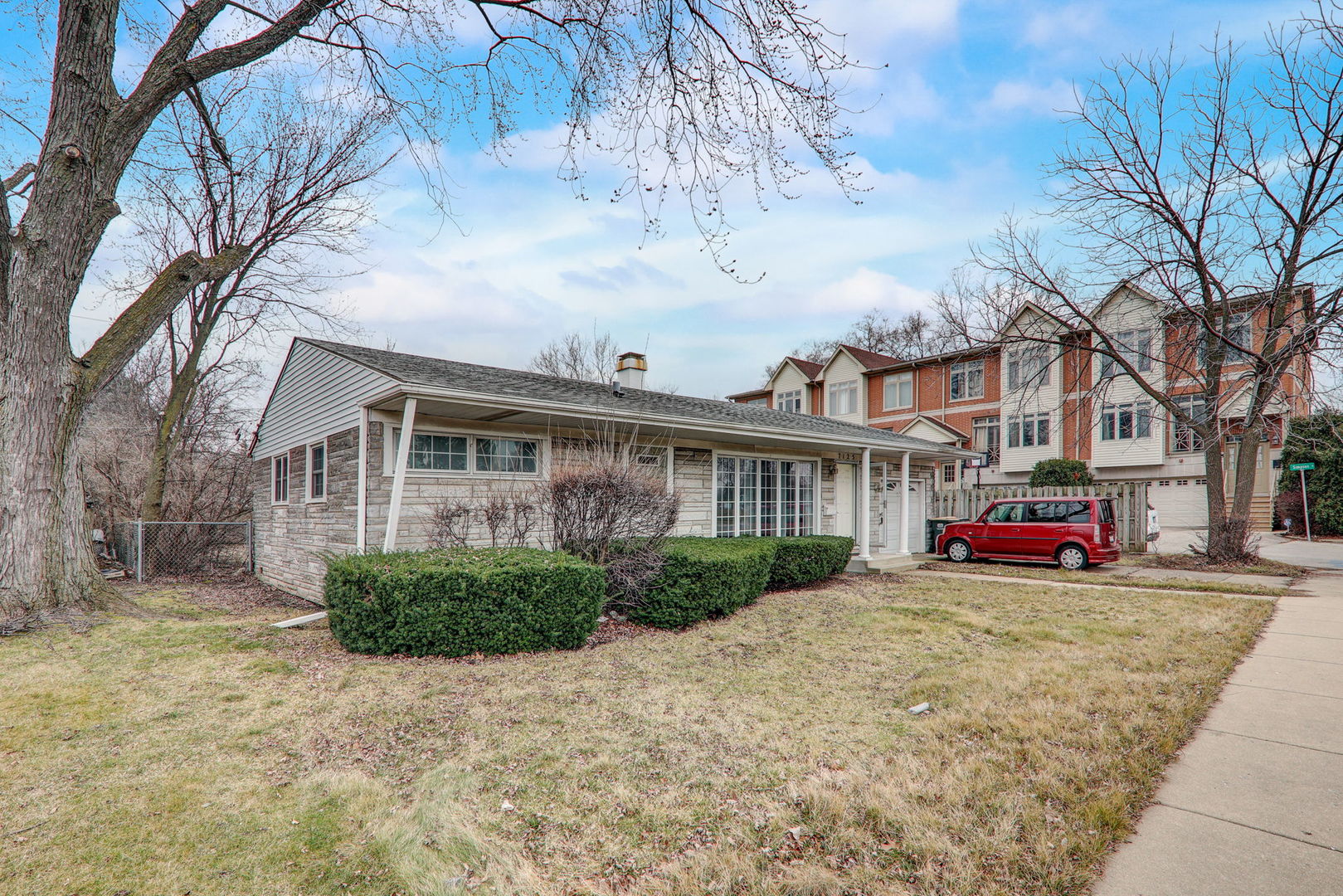 7125 Simpson Street Morton Grove, IL 60053 - Photo 3 of 28 a view of a house next to a big yard with large trees