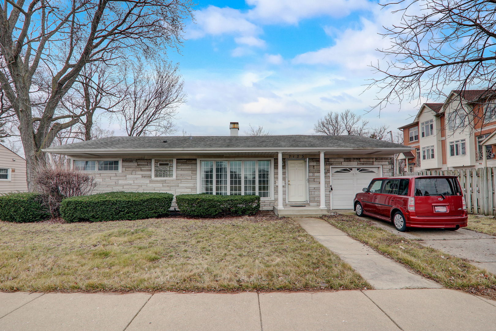 7125 Simpson Street Morton Grove, IL 60053 - Photo 4 of 28 a front view of a house with a garden