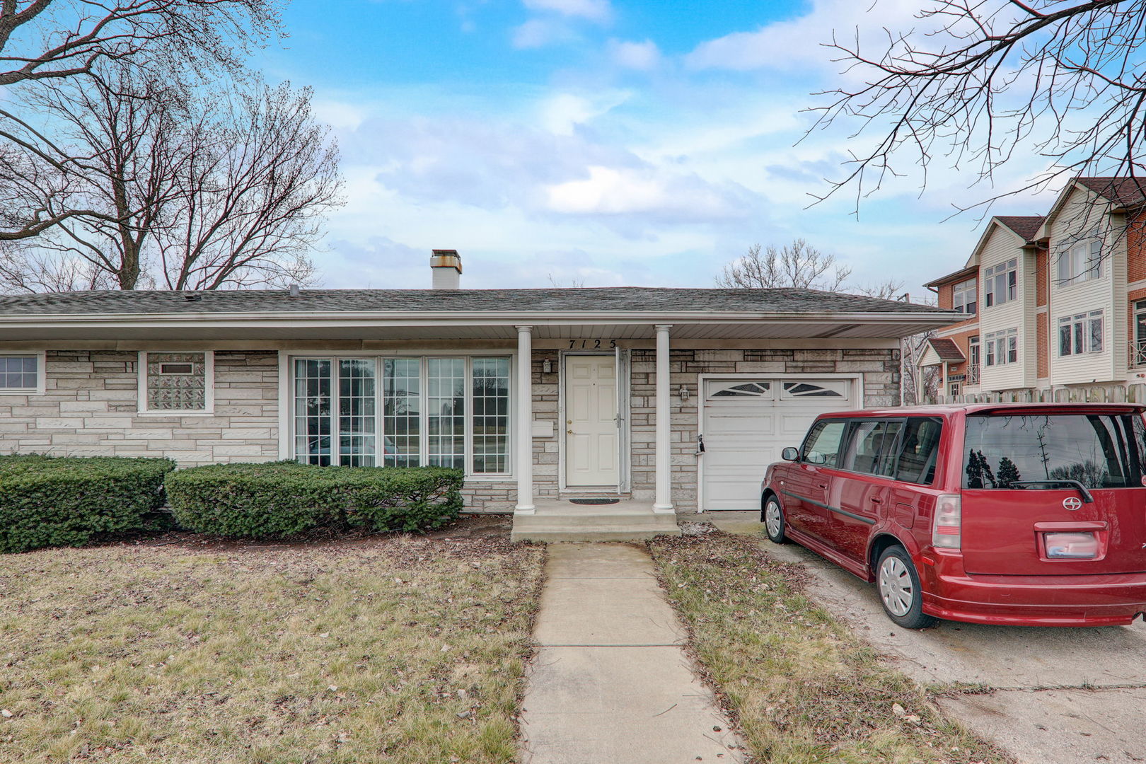 7125 Simpson Street Morton Grove, IL 60053 - Photo 6 of 28 a front view of a house with a garden