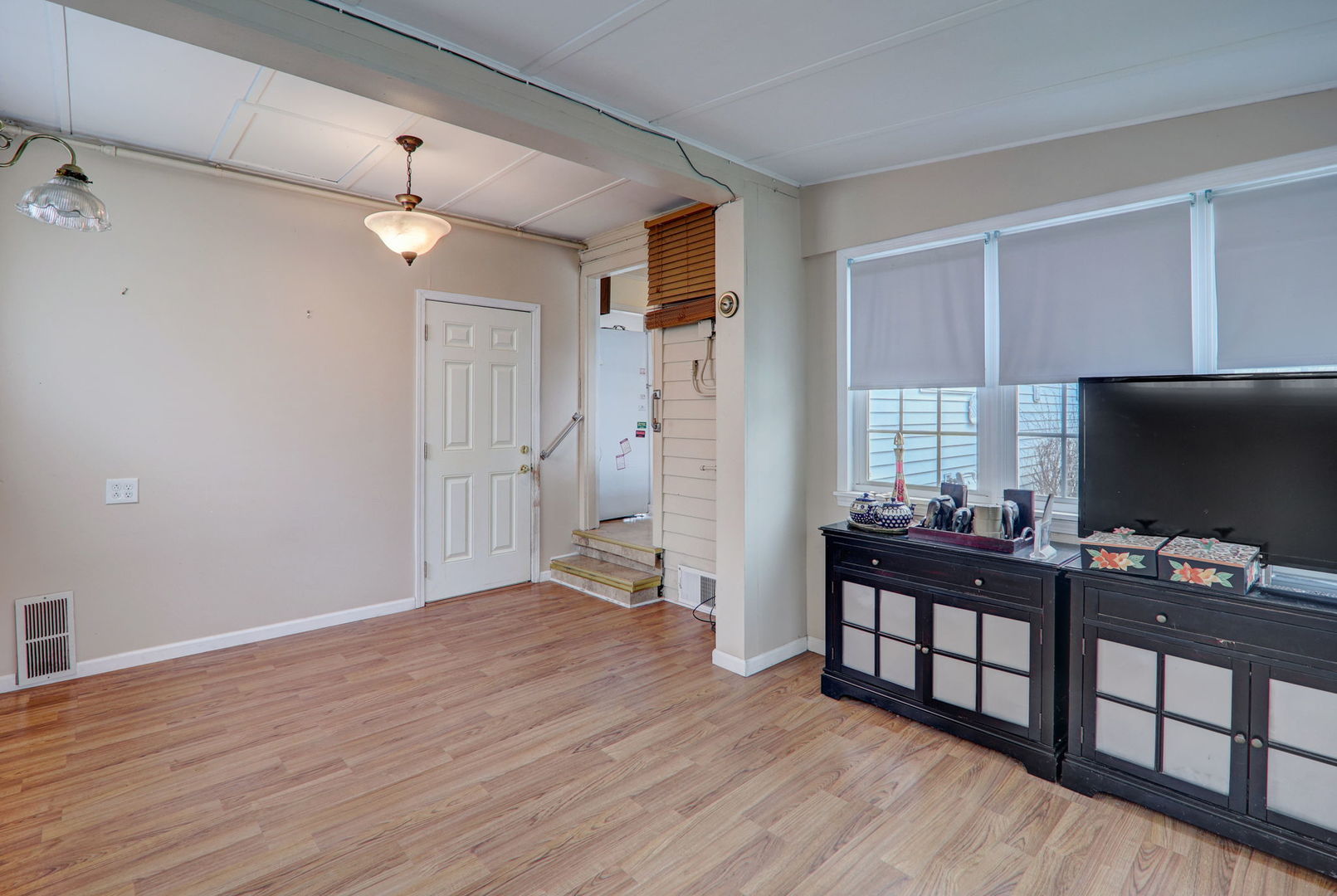 7125 Simpson Street Morton Grove, IL 60053 - Photo 9 of 28 an empty room with wooden floor and windows